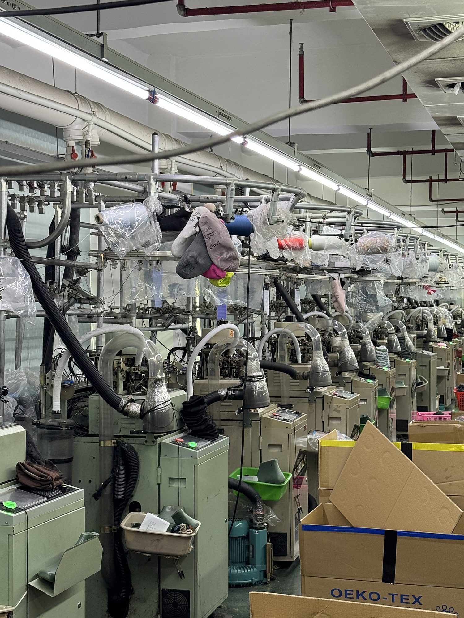 Computerised flyknit machine lines inside the Quanzhou sock shoe factory
